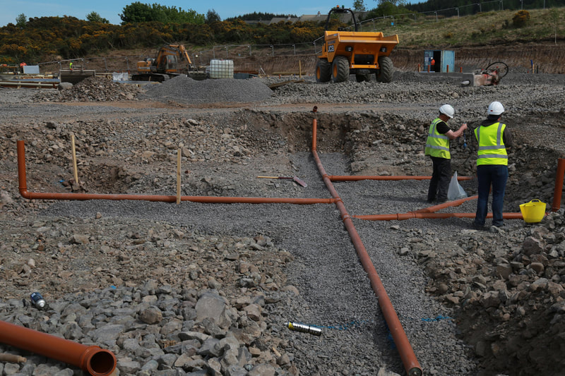 Engineers setting out the pipework for a housing developement
