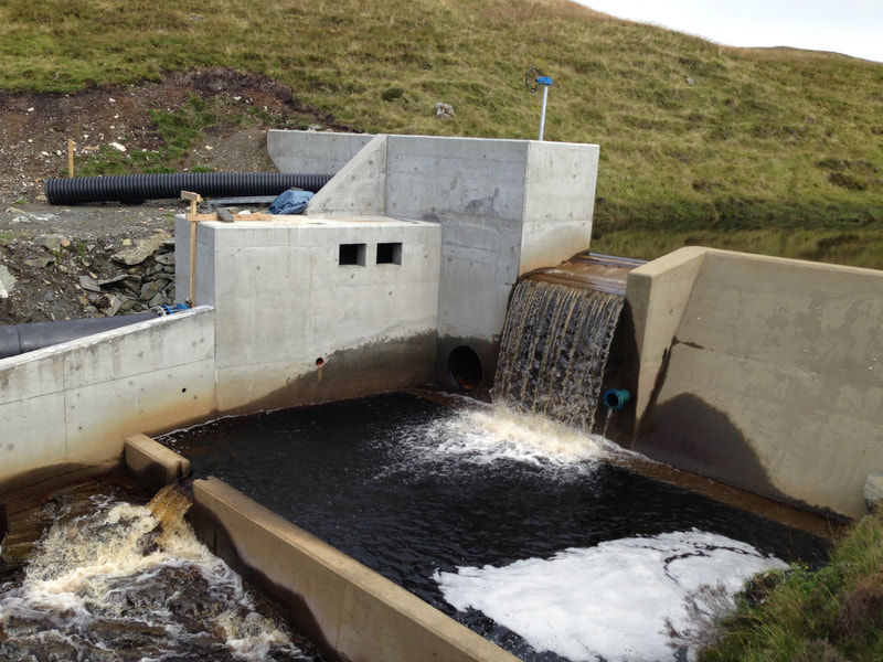 A completed hydro intake showing water spilling into the fish pool